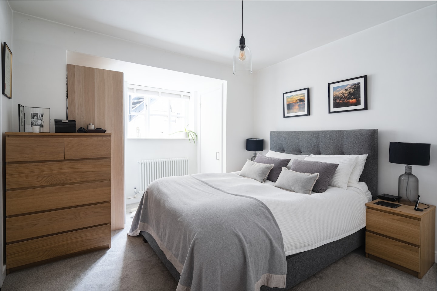 Bright bedroom with a large double bed and oak furniture